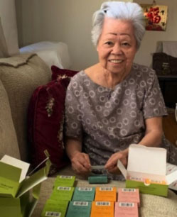 photo of Jane Yang sitting at a table with Heart to Heart Cards