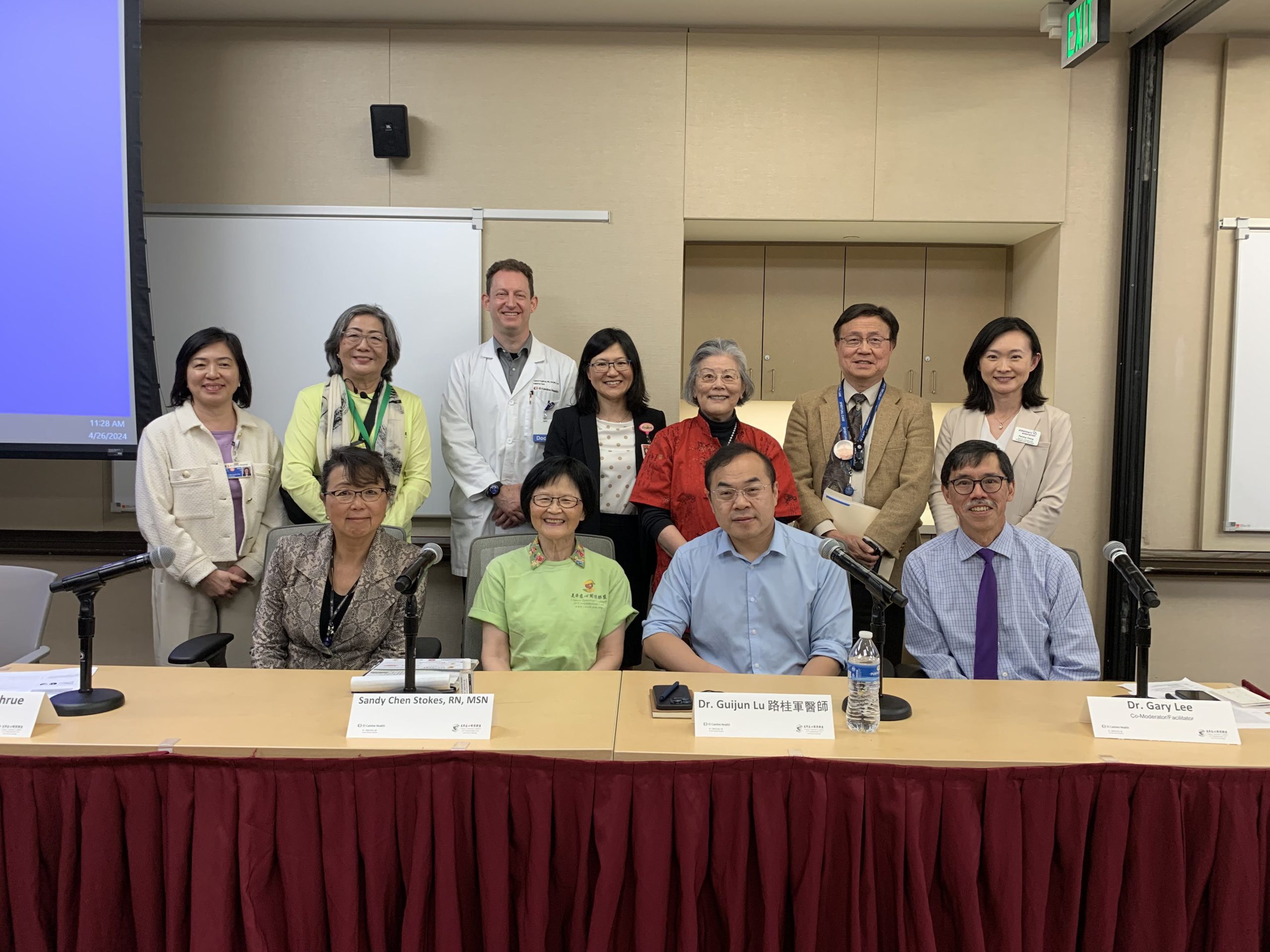 Dr. Guijun Lu seated with other medical professionals in group photo