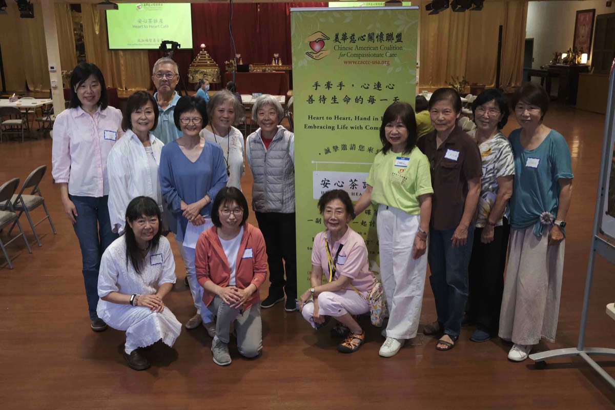 participants standing in front of CACCC banner