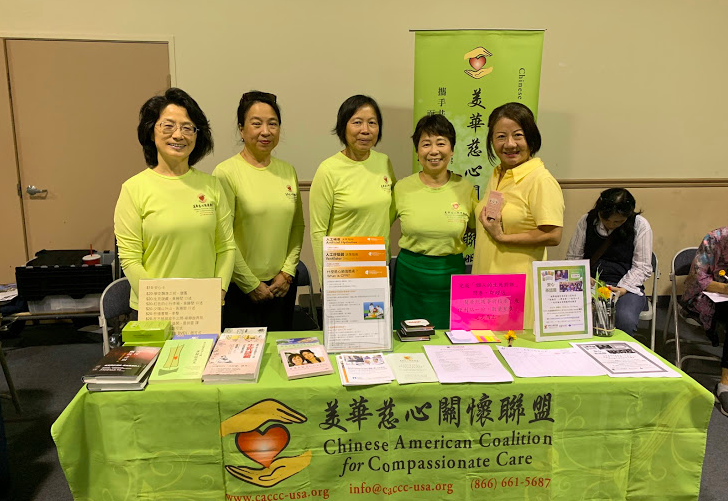 CACCC volunteers standing behind CACCC table