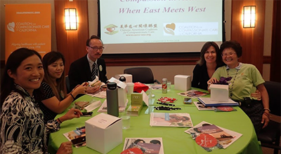 Participants around table looking into camera