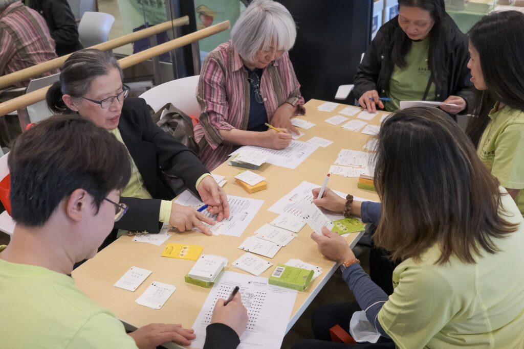 Participants playing cards at Heart to Heart Cafe