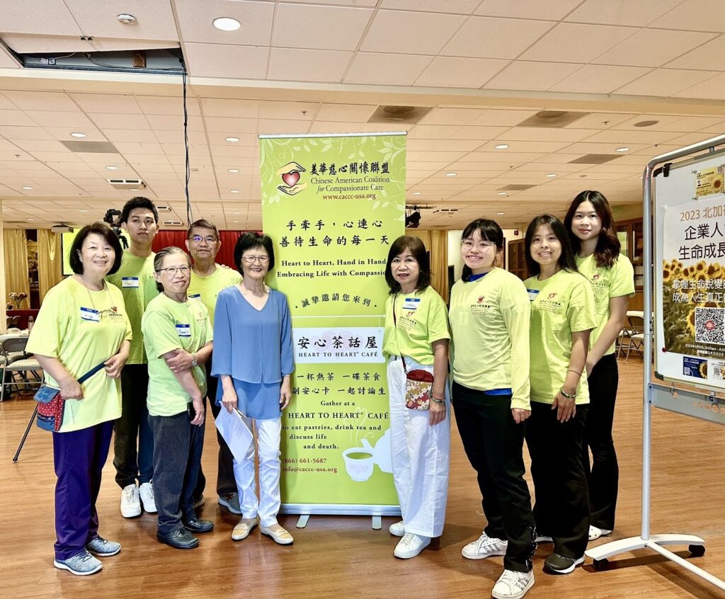 CACCC volunteers smiling in front of CACCC banner at event