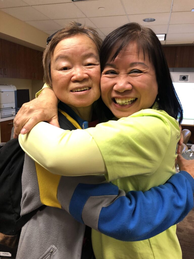 CACCC volunteer embracing attendee