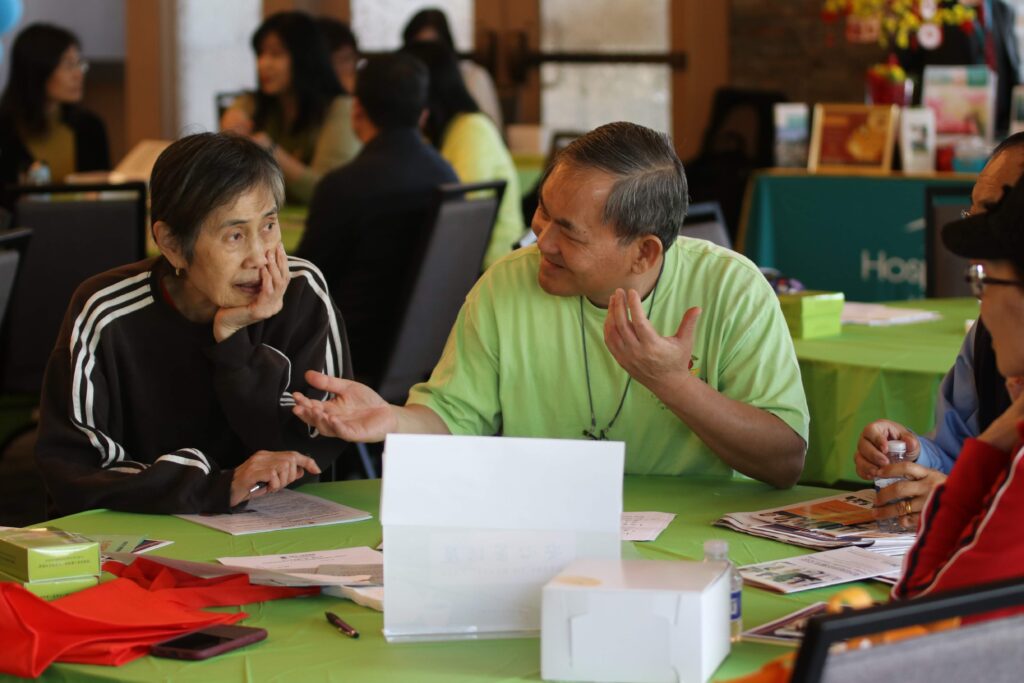 Volunteer enthusiastically facilitating conversation at event